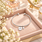 Silver round pendant Christian bracelet with So Blessed and Love charms styled in a soft pink jewellery tray with flowers