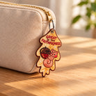 Great Is Thy Faithfulness embroidered Christian keychain hanging from a beige pouch zipper