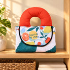 Fruit of the Spirit Christian picnic mat folded on a wooden shelf in a warm home