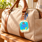Hello My Beloved Child biscuit acrylic keychain hanging from a beige canvas bag