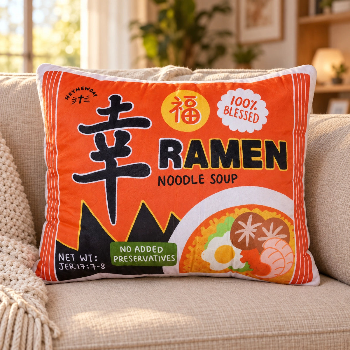 Xin Blessed Ramen Christian plush toy styled on a cosy sofa in a warm living room