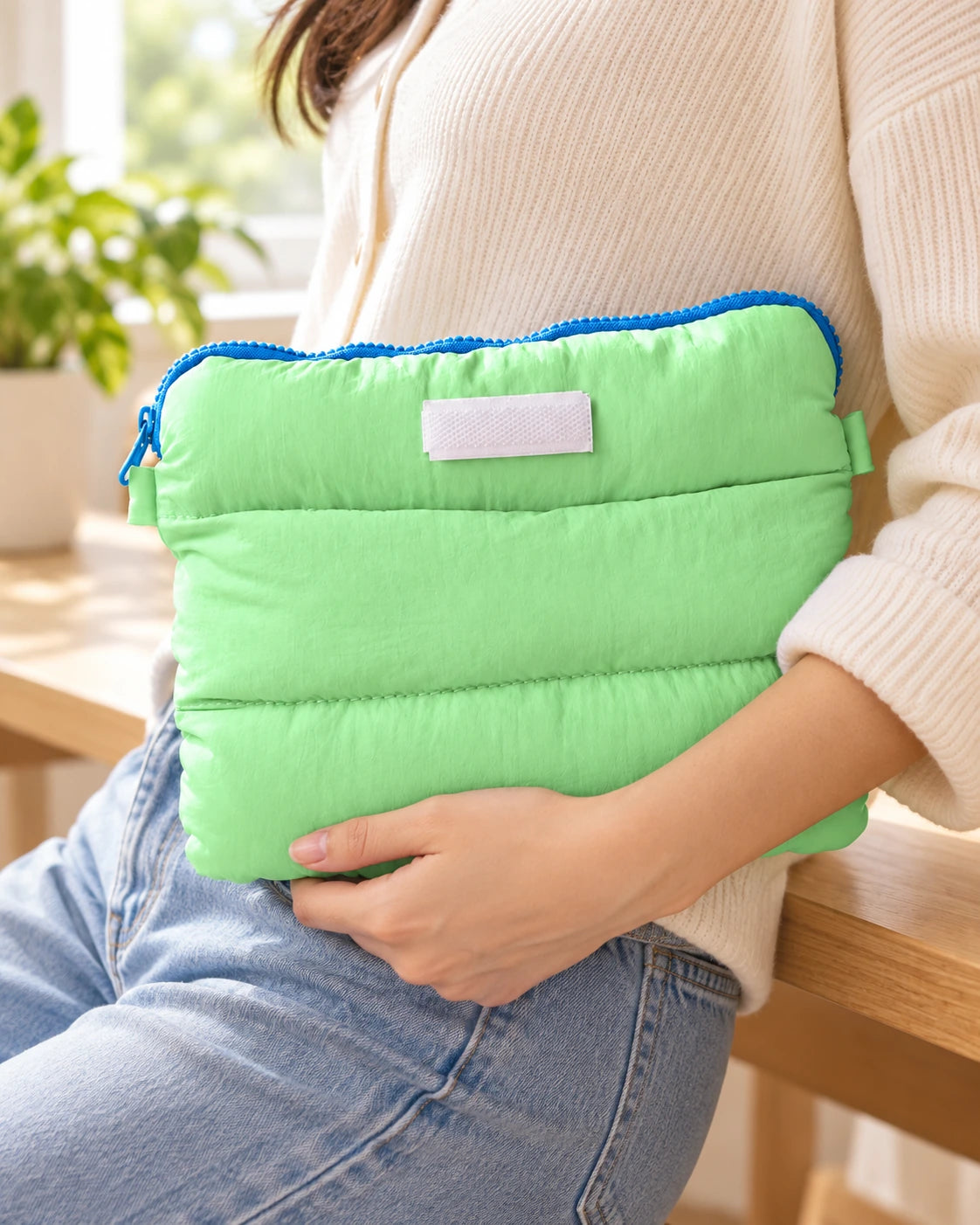 Mint Pong Pong multi purpose bag held against a person's side in a bright casual lifestyle setting