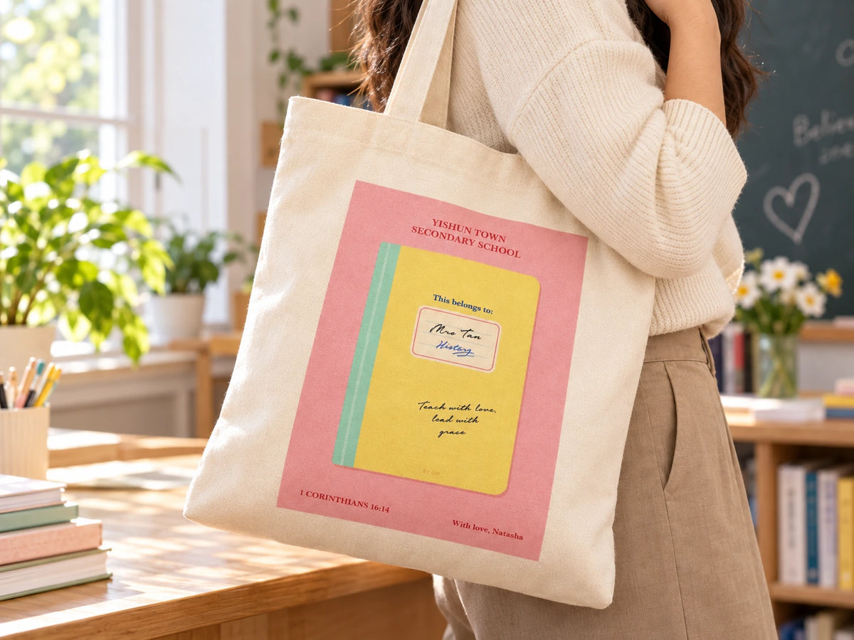 Customisable Teacher's Notebook tote bag worn over the shoulder in a bright classroom setting