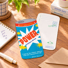 Power energy drink shaped Christian greeting card front and back laid flat on a wooden desk