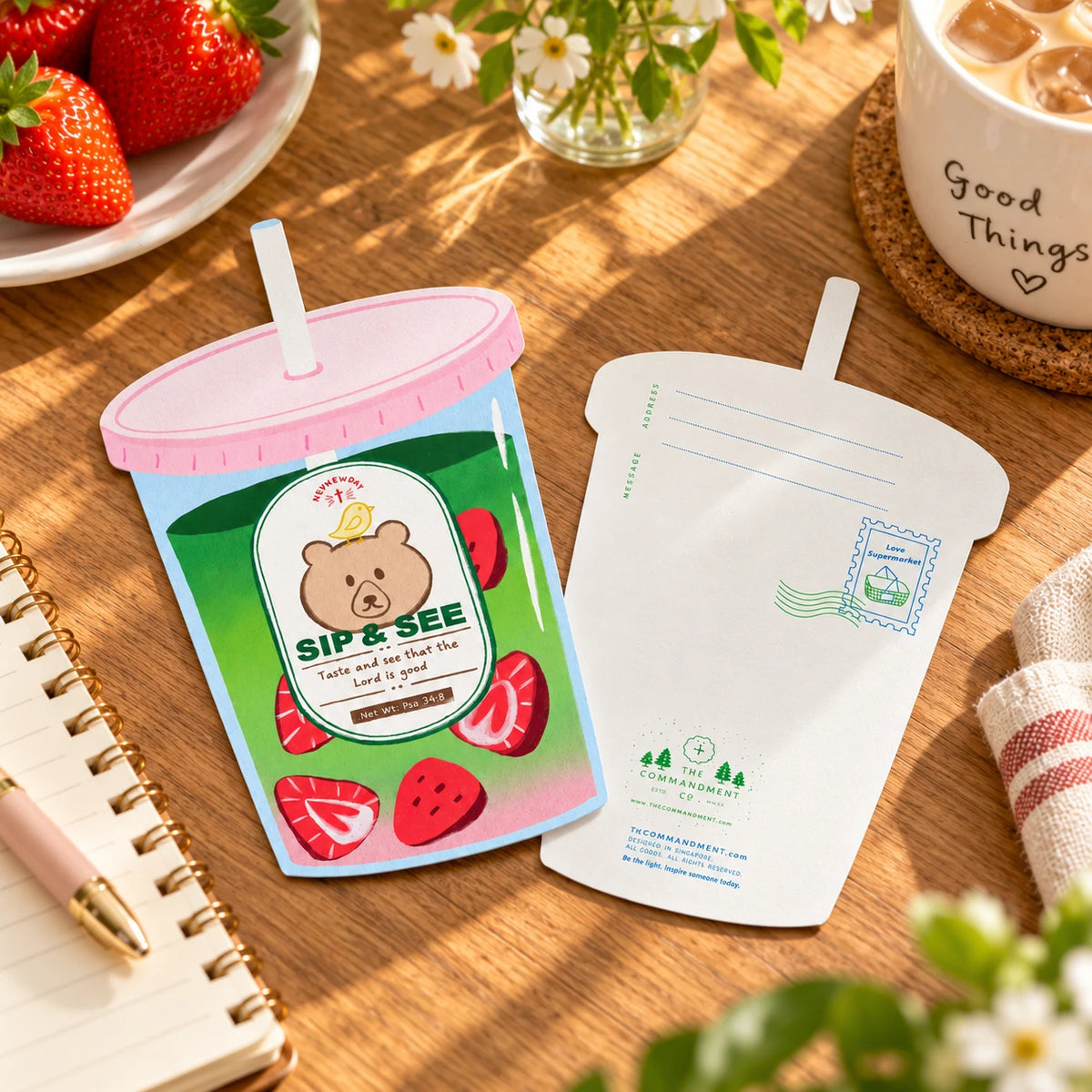 Taste and See matcha drink shaped card, front and back laid flat on a wooden tabletop