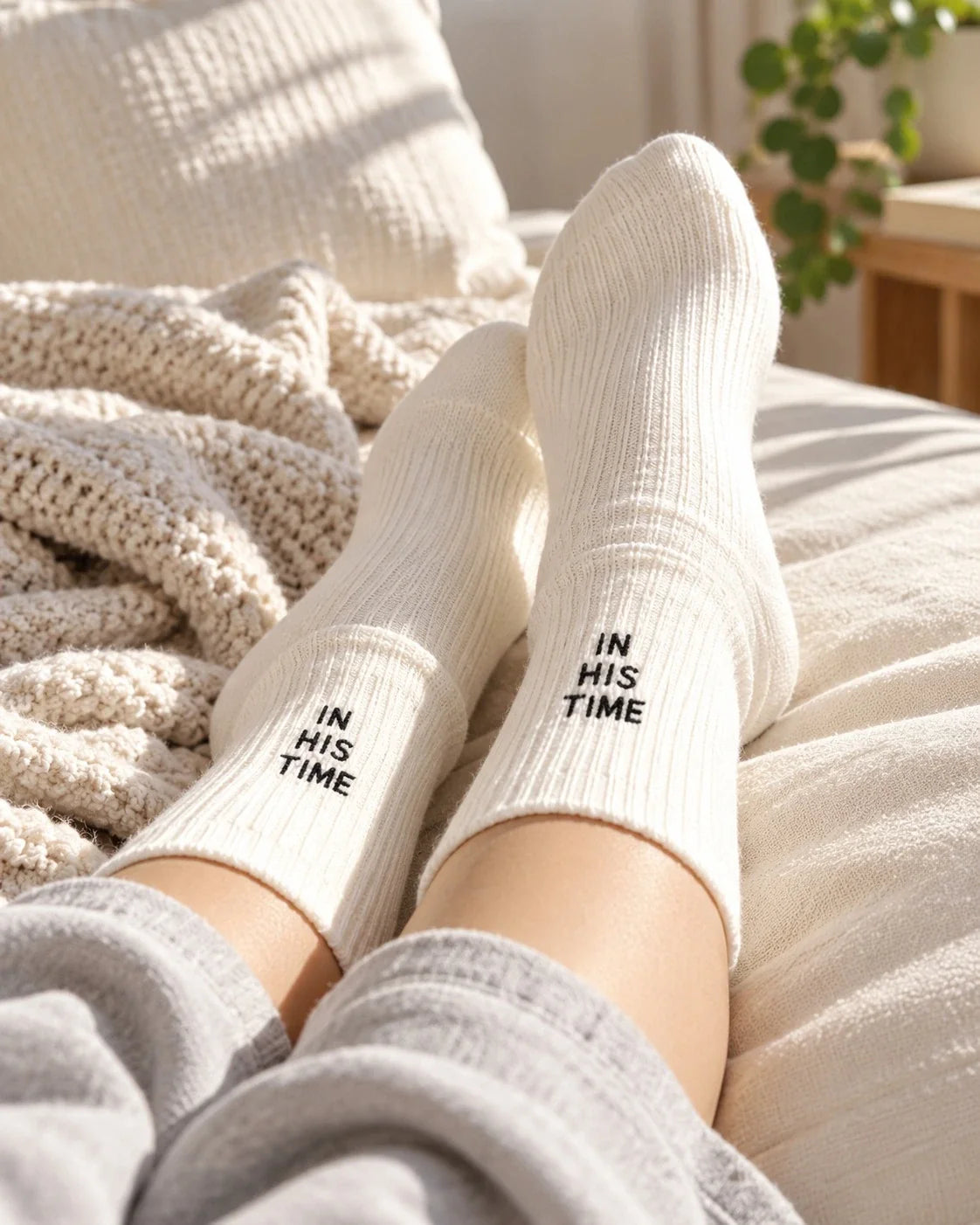 White In His Time socks styled in a cosy room