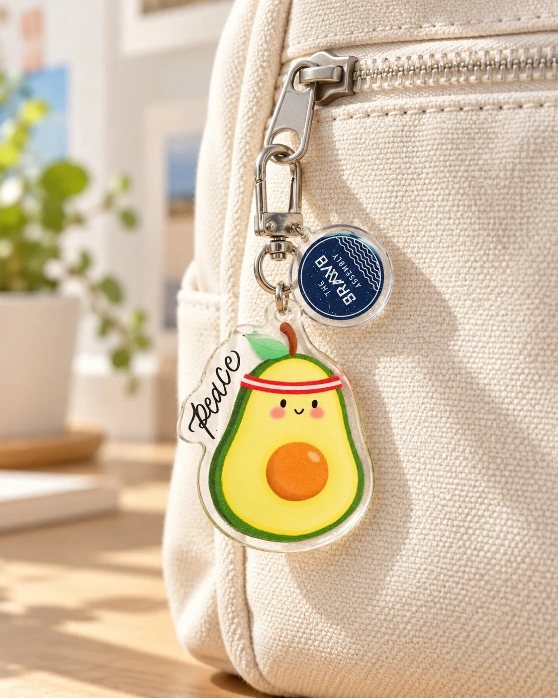 Peace avocado acrylic keychain hanging from backpack zip