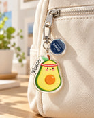 Peace avocado acrylic keychain hanging from backpack zip