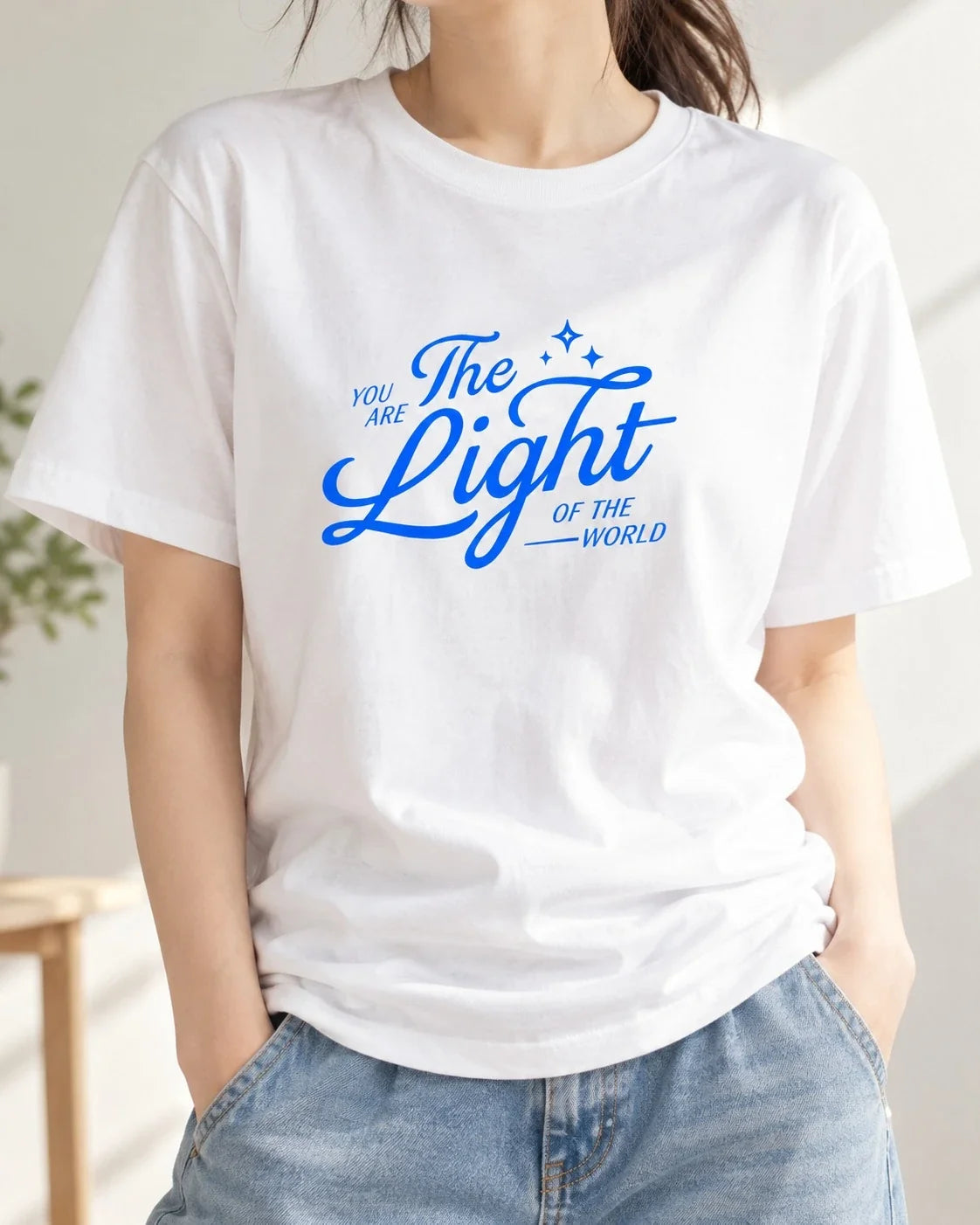 Blue You Are The Light print on white T-shirt worn with jeans