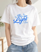 Blue You Are The Light print on white T-shirt worn with jeans