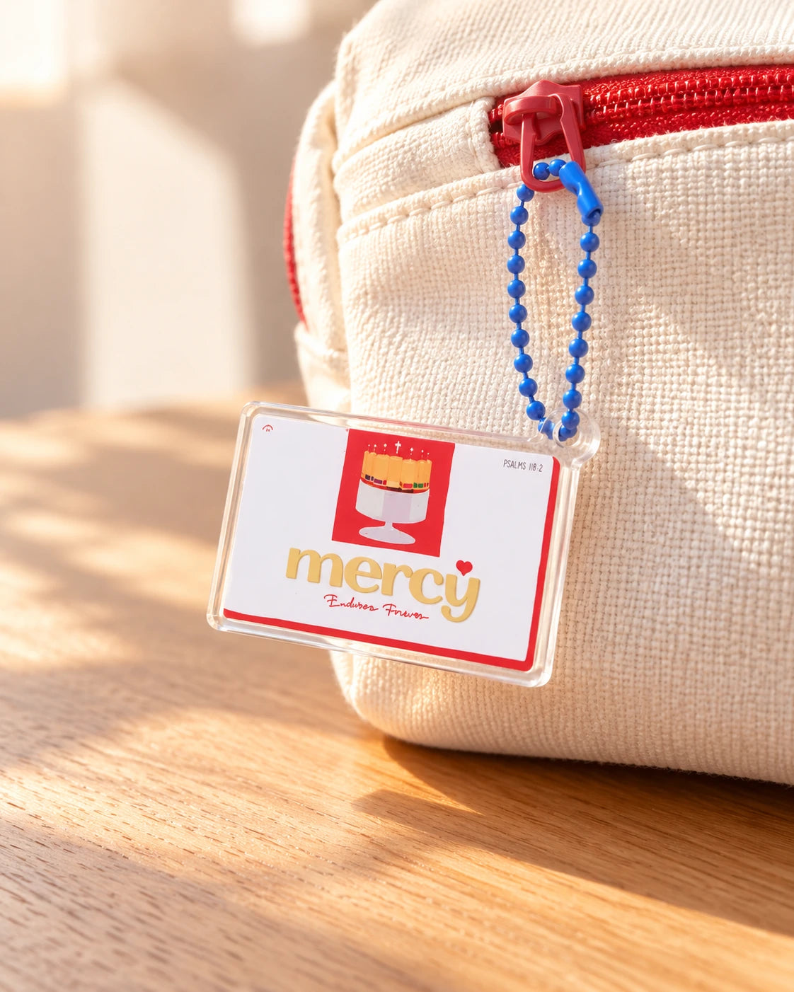 His Mercy Endures Forever chocolate-bar acrylic keychain on cream pouch zipper