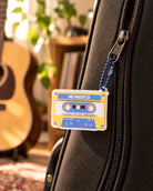 Cassette Tape A Child in His Presence acrylic keychain hanging from a guitar case