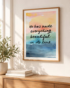 He Has Made Everything Beautiful Bible verse poster with pastel watercolour artwork displayed in a wooden frame above a sideboard