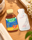 Joyful Heart Medicine LOVE SUPERMARKET card front and back displayed on a wooden desk beside a notebook