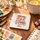 Keep in Perfect Peace white coaster beside watercolour painting supplies and lemon water