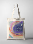 A pastel-colored tote bag showcasing swirling shades of blue, purple, orange, and pink. The design includes a crescent moon and the Bible verse Psalm 94:19: 'In the multitude of my anxieties within me, Your comforts delight my soul.' A modern Christian gift blending practicality and inspiration.