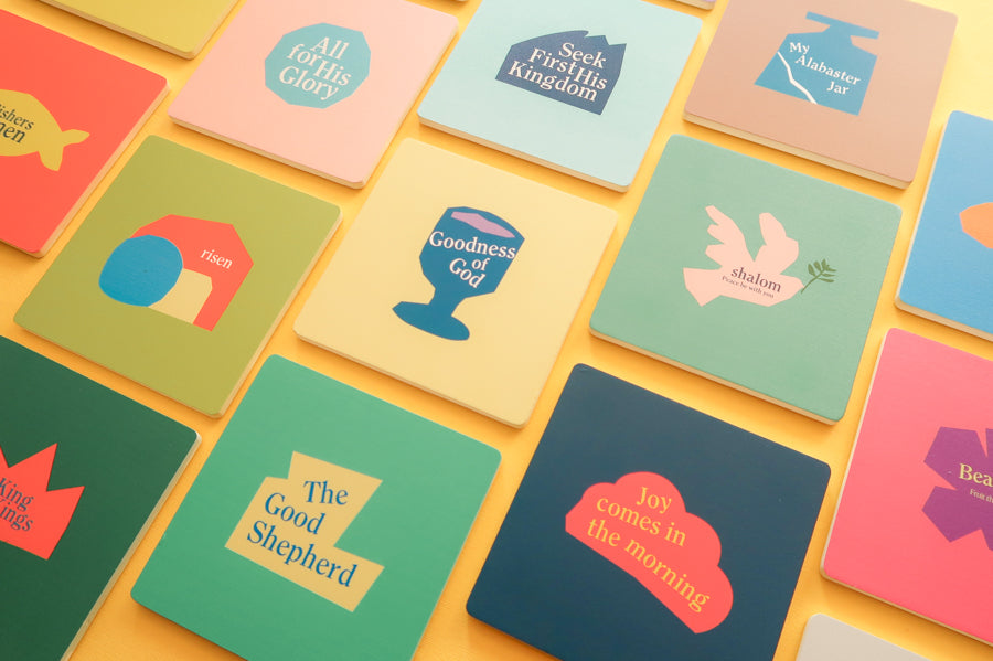 Divine Wooden Coasters: Colorful square coasters adorned with Christian symbols.