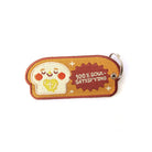 Cute bread-themed keychain with an embroidered smiley face and the phrase '100% Soul-Satisfying'.