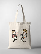 Faith-inspired tote bag featuring a cute illustration of Jesus joyfully pointing hearts at a dancing child, symbolizing love and celebration.