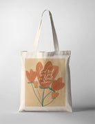 A beige tote bag featuring hand-drawn orange flowers and the words: 'Find rest my soul in Christ alone.' This modern Christian gift combines gentle floral art with an uplifting message for daily encouragement.