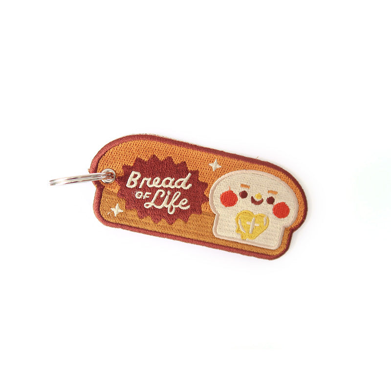 Inspirational embroidered keychain with a bread design and the message 'Bread of Life'.