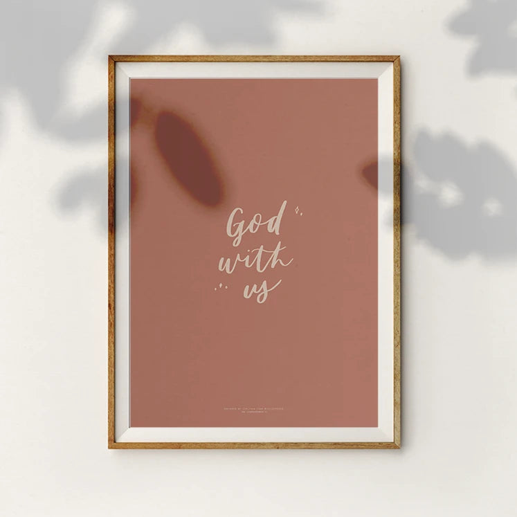 Inspirational poster featuring the words 'God with us' in a modern calligraphy style on a pink background.