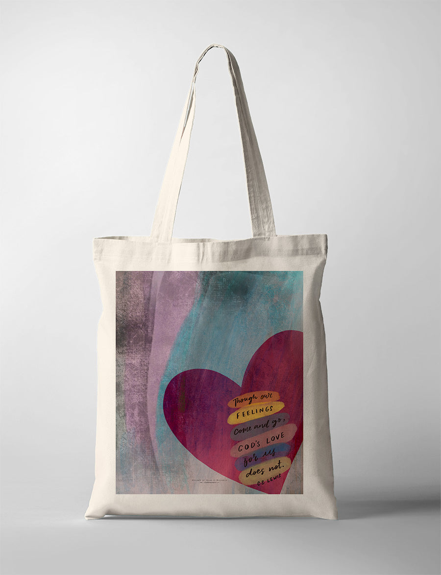 A tote bag with a bold, abstract design of a heart set against a textured purple and teal background. The heart features a layered C.S. Lewis quote: 'Though our feelings come and go, God's love for us does not.' A thoughtful modern Christian gift for all occasions.