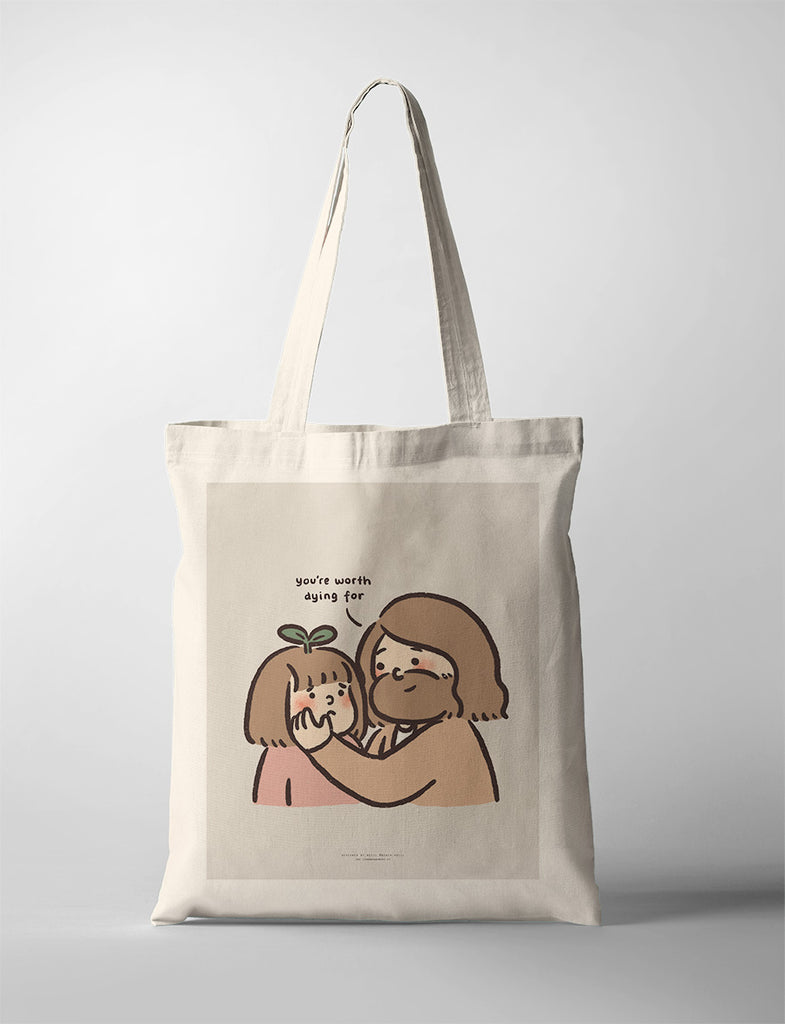 Canvas tote bag featuring a touching illustration of Jesus gently holding a child's face with the words 'You're worth dying for,' expressing deep love and value.