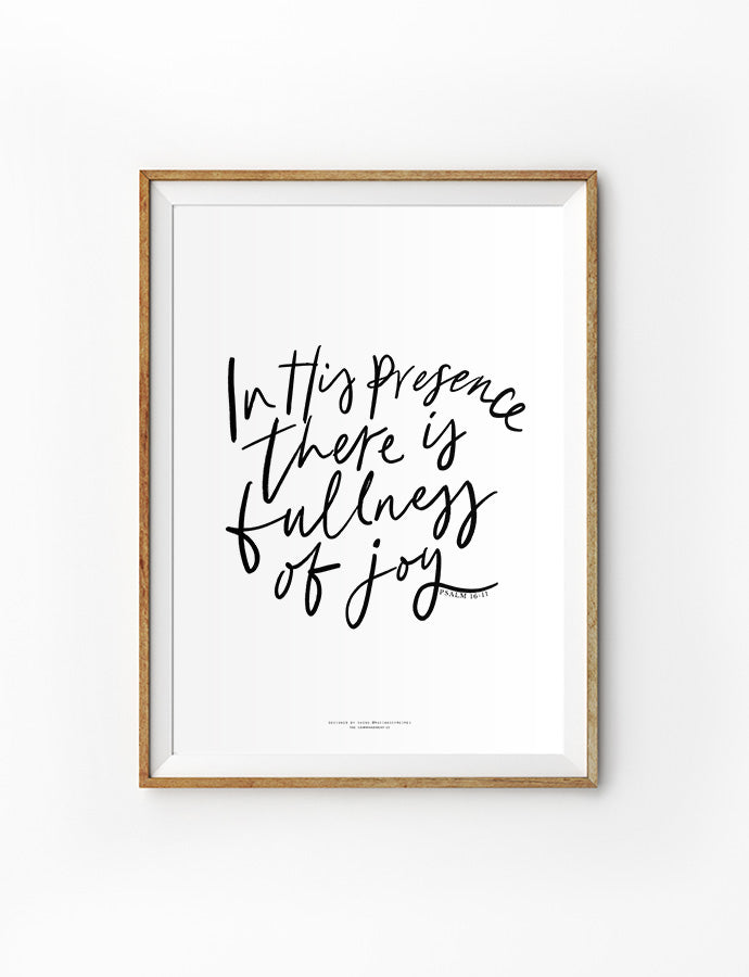 A framed poster with a handwritten-style quote reading 'In His presence there is fullness of joy' from Psalm 16:11, in black ink on a white background.