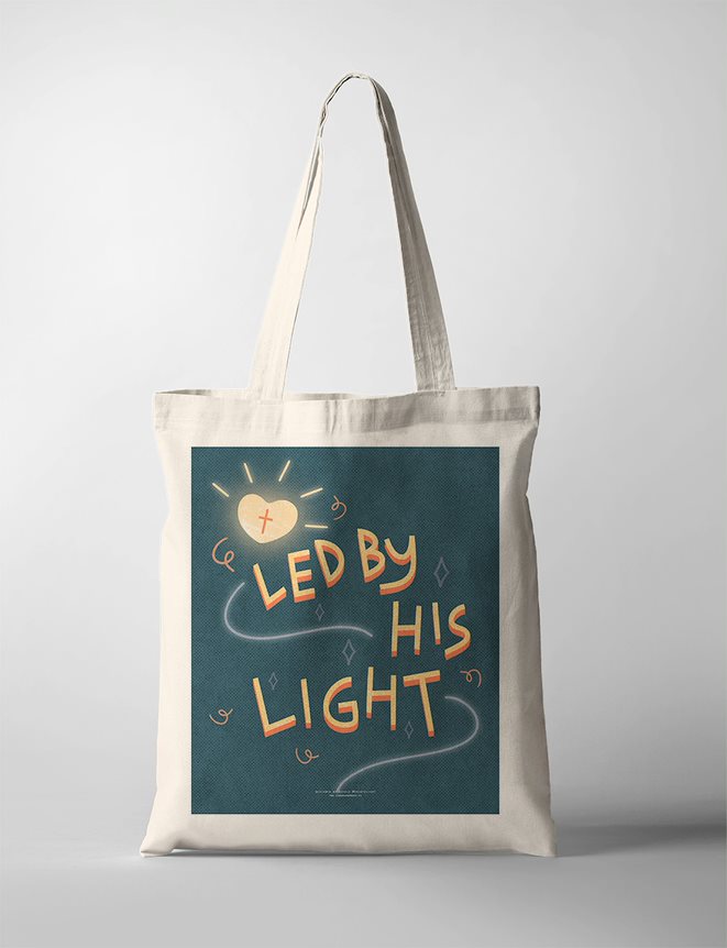 A faith based Tote Bag featuring an inspirational quote, "Led by His Light" displayed on a canvas tote bag. The design includes a glowing lantern amidst a dark teal background, emphasizing themes of hope and guidance. The uplifting message on the faith based poster encourages inner light and positivity