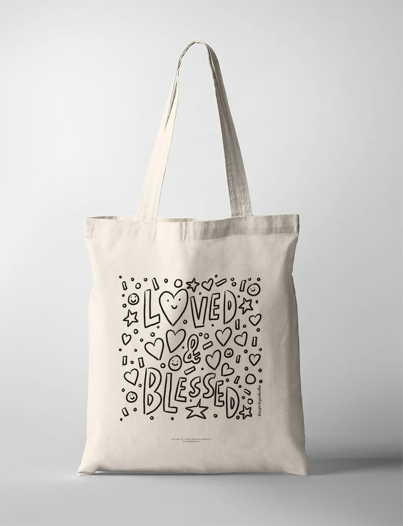 Illustrative tote bag with 'Loved & Blessed' text surrounded by playful heart and star doodles