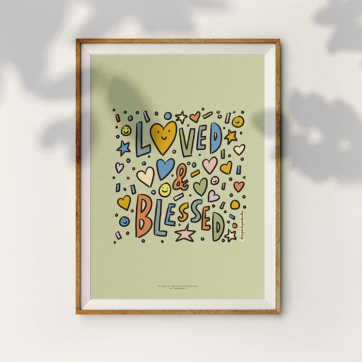 Joyful home decor featuring 'Loved & Blessed' text with colorful and happy doodles