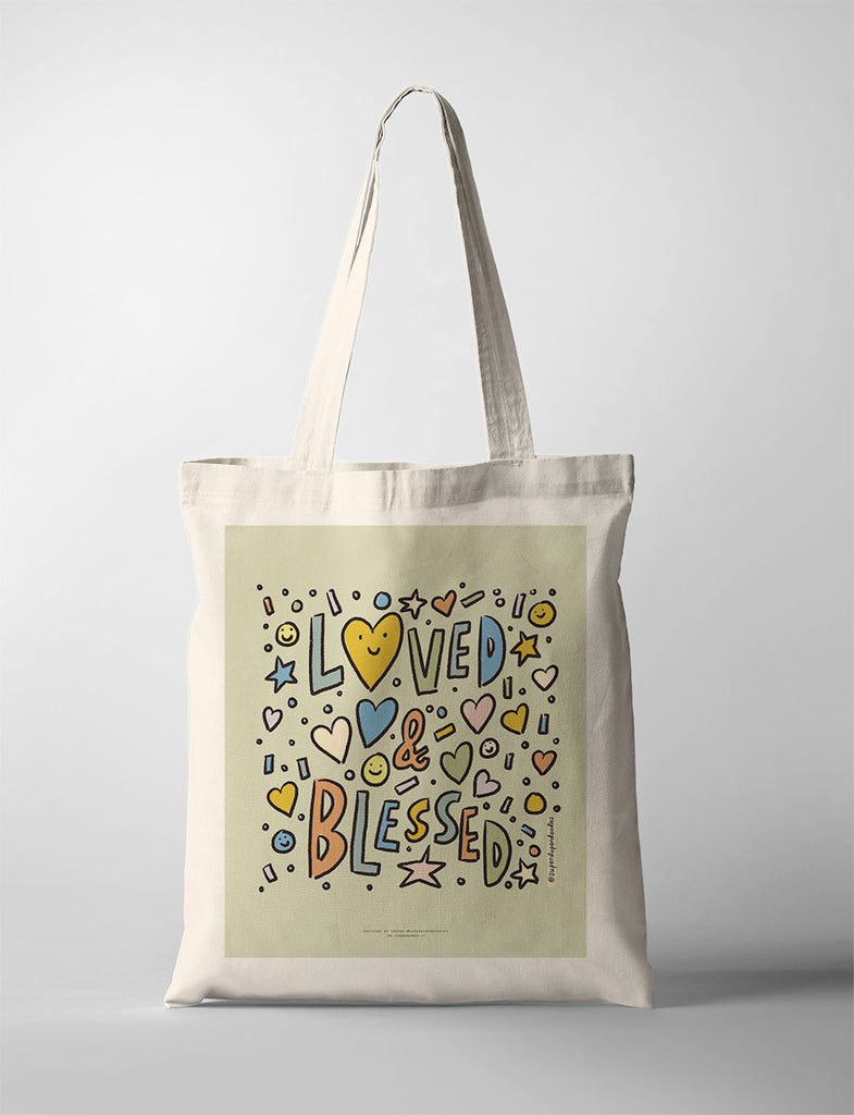 Modern tote bag featuring 'Loved & Blessed' text and vibrant heart and star illustrations