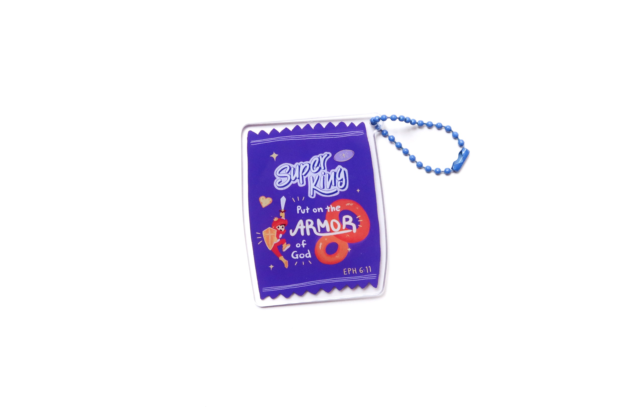 ‘Super King – Put on the Armor of God’ acrylic keychain shaped like a purple snack packet, featuring a cute illustrated warrior and a blue beaded chain.