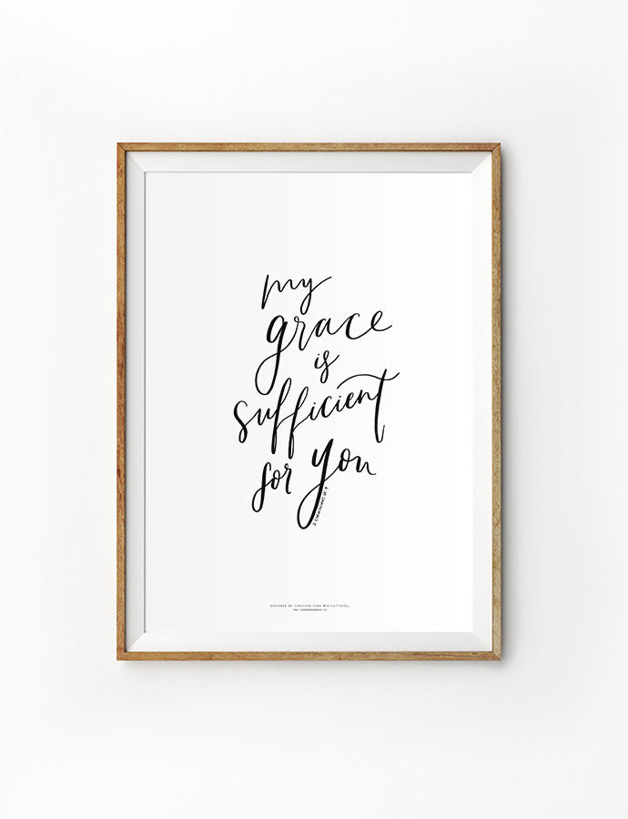 Framed minimalist wall art with the phrase 'My grace is sufficient for you' in elegant black script.