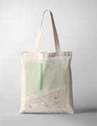 Minimalist canvas tote bag featuring a serene indoor scene with a green curtain, an open book, and a cup of coffee on a sunny morning, evoking peace and relaxation.