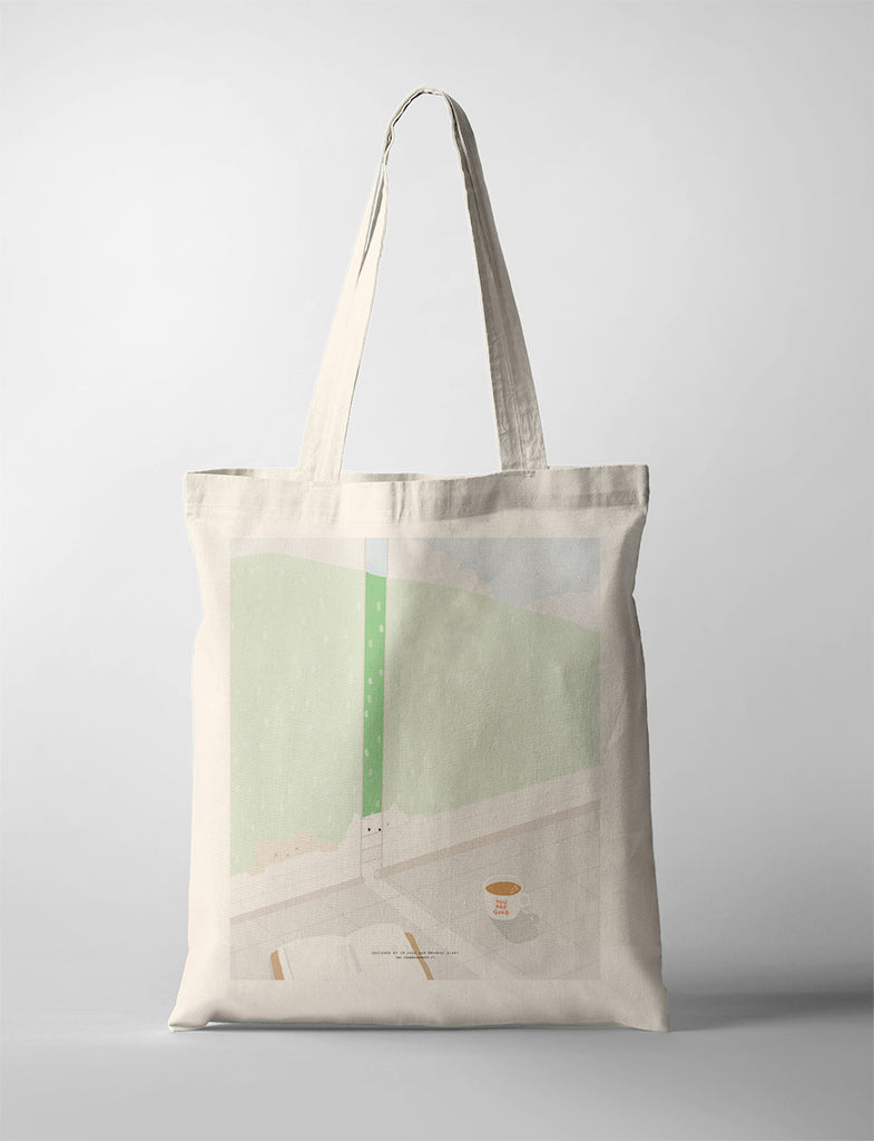 Minimalist canvas tote bag featuring a serene indoor scene with a green curtain, an open book, and a cup of coffee on a sunny morning, evoking peace and relaxation.