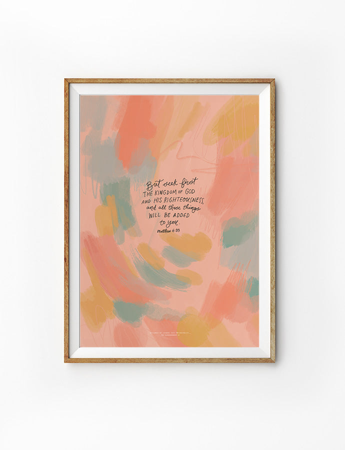 A Christian wall poster with an abstract painted background in soft coral, peach, mustard, and teal tones. The hand-lettered Bible verse in the center reads: “But seek first the kingdom of God and His righteousness, and all these things will be added to you.” The design is framed in light wood, combining faith with modern artistry.