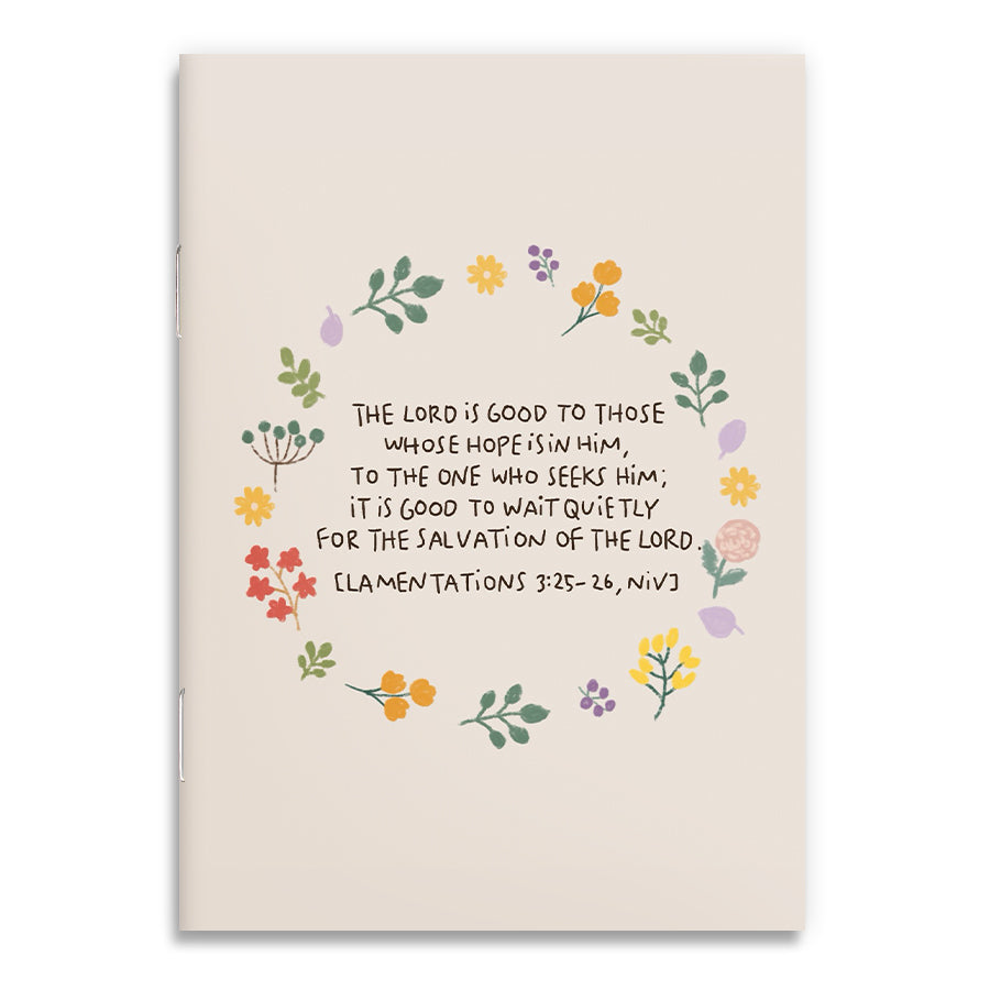 A6 Christian notebook featuring a soft floral wreath illustration surrounding the Bible verse “The Lord is good to those whose hope is in Him” from Lamentations 3:25–26 (NIV), in collaboration with Moojigae Drawing.