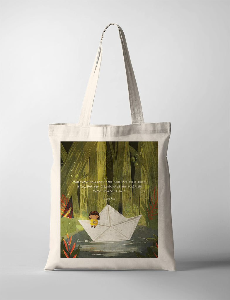 Beige tote bag featuring a whimsical illustration of a child in a paper boat surrounded by nature, accompanied by the Bible verse Psalm 9:10: 'And those who know Your name put their trust in You, for You, O Lord, have not forsaken those who seek You.' The design evokes themes of trust and faith in God's protection.