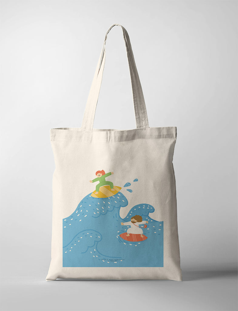 Canvas tote bag featuring a vibrant illustration of two characters surfing on blue waves, representing adventure, fun, and the joy of overcoming challenges together.