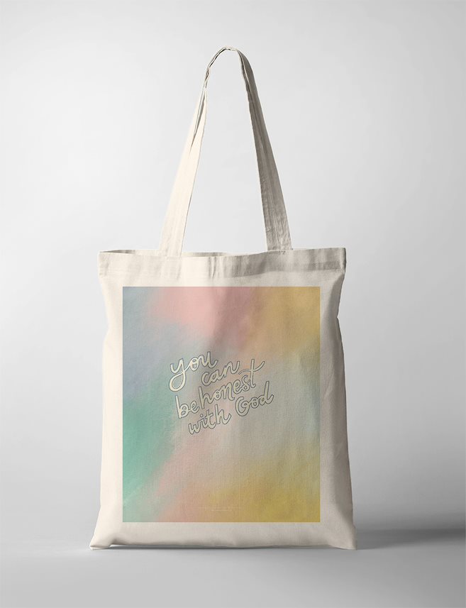 Faith-based Christian tote bag with pastel watercolor background and the inspirational message "You can be honest with God" written in white script on the front.