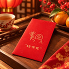 A Flower For You red packet on a wooden tray with tea and mandarin oranges in a Lunar New Year setting.