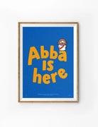 Abba Is Here Christian poster with bold orange lettering on a blue background and a small Jesus illustration
