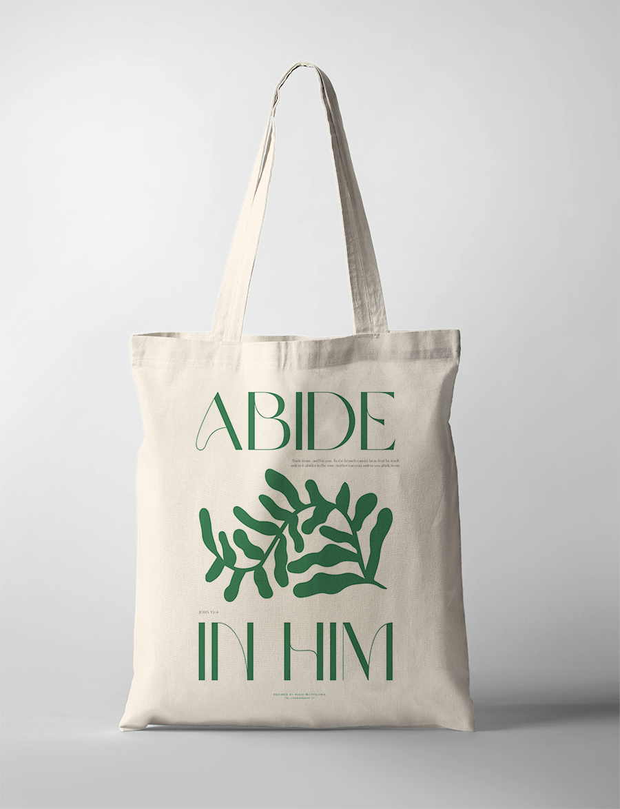 Neutral canvas tote bag featuring green botanical artwork and the uplifting Christian message "Abide in Him" by Littulines, reflecting simple happiness and faith-inspired living.