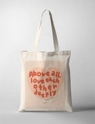 Christian canvas tote bag with “Above all, love each other deeply” typography inspired by 1 Peter 4:8, created in collaboration with Moojigae Drawing