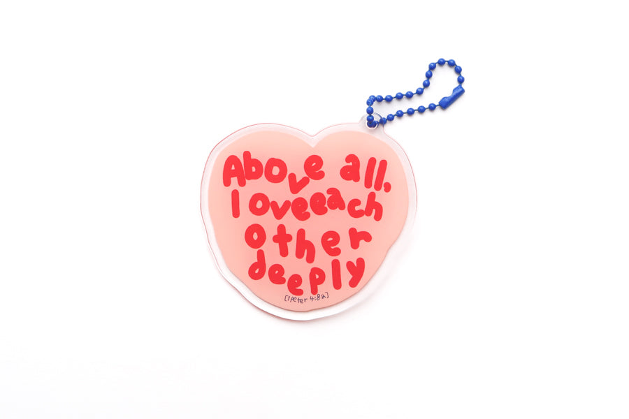 Heart-shaped acrylic keychain with the phrase “Above all, love each other deeply” from 1 Peter 4:8, Christian encouragement keychain in collaboration with moojigae_drawing.