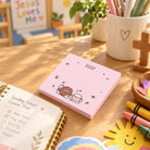 Pink Always Blessed sticky note pad with cute Jesus and sheep illustration on a sunny stationery desk
