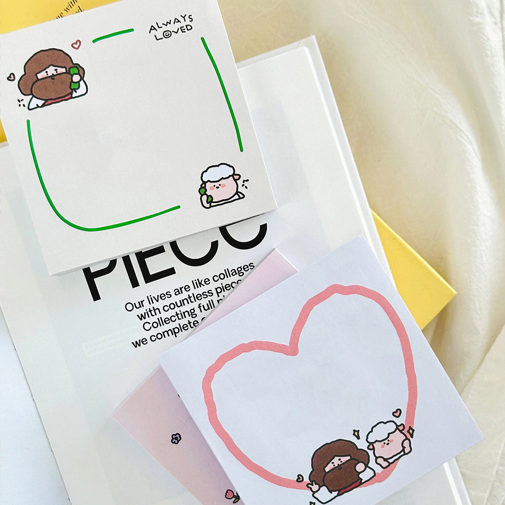 Two Christian-themed sticky notes on top of a book, one with a pink heart featuring Jesus and a sheep, and another with green accents and the phrase 'Always Loved,' ideal for faith-based stationery.