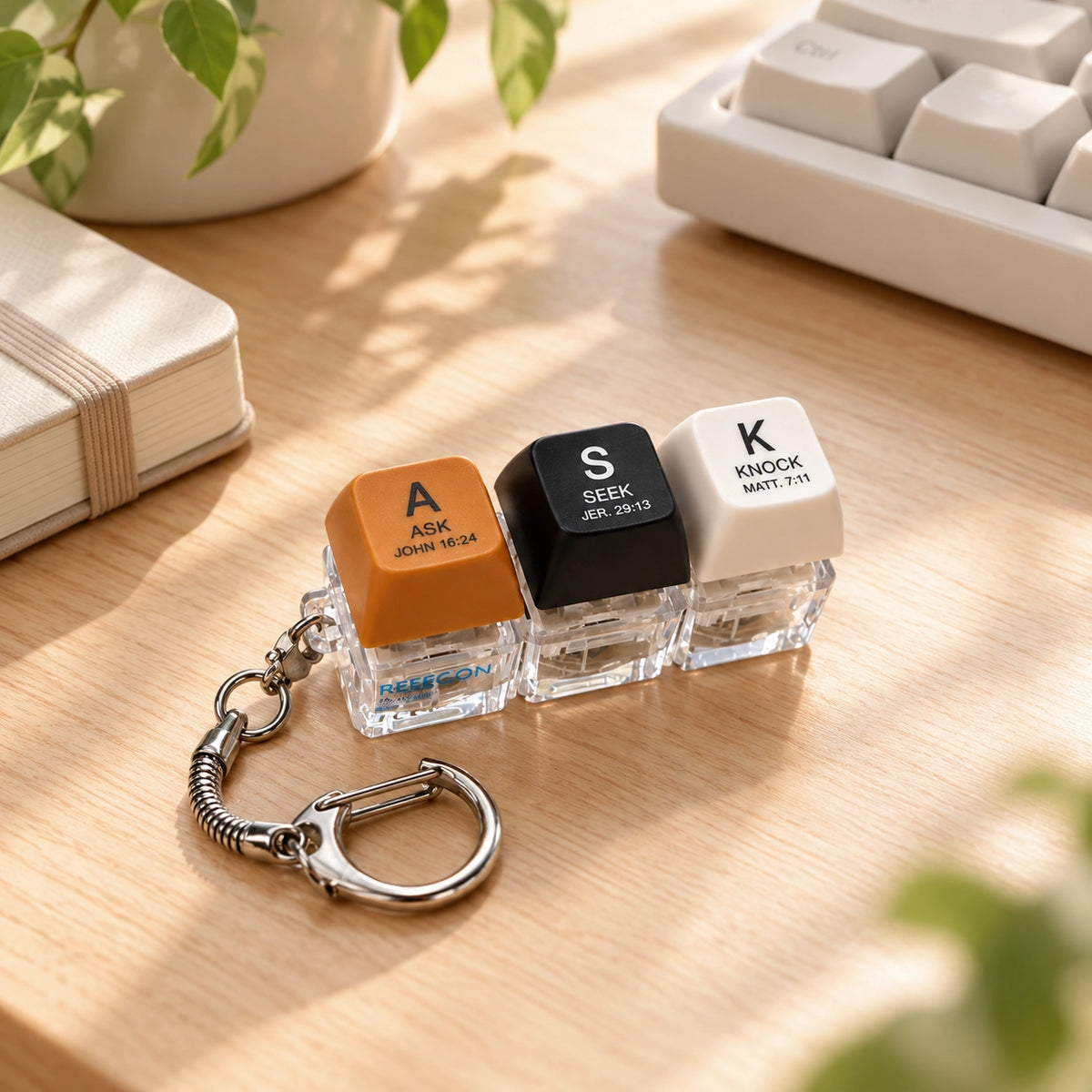ASK SEEK KNOCK light-up keycap keychain lifestyle with keyboard and book 